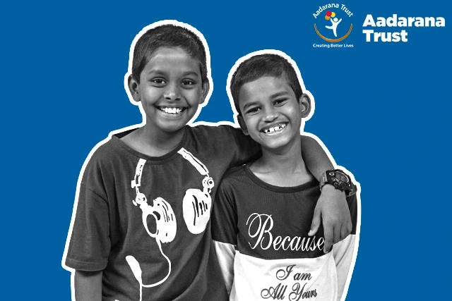 Aadarana campaign artwork with two boys smiling together against a blue background